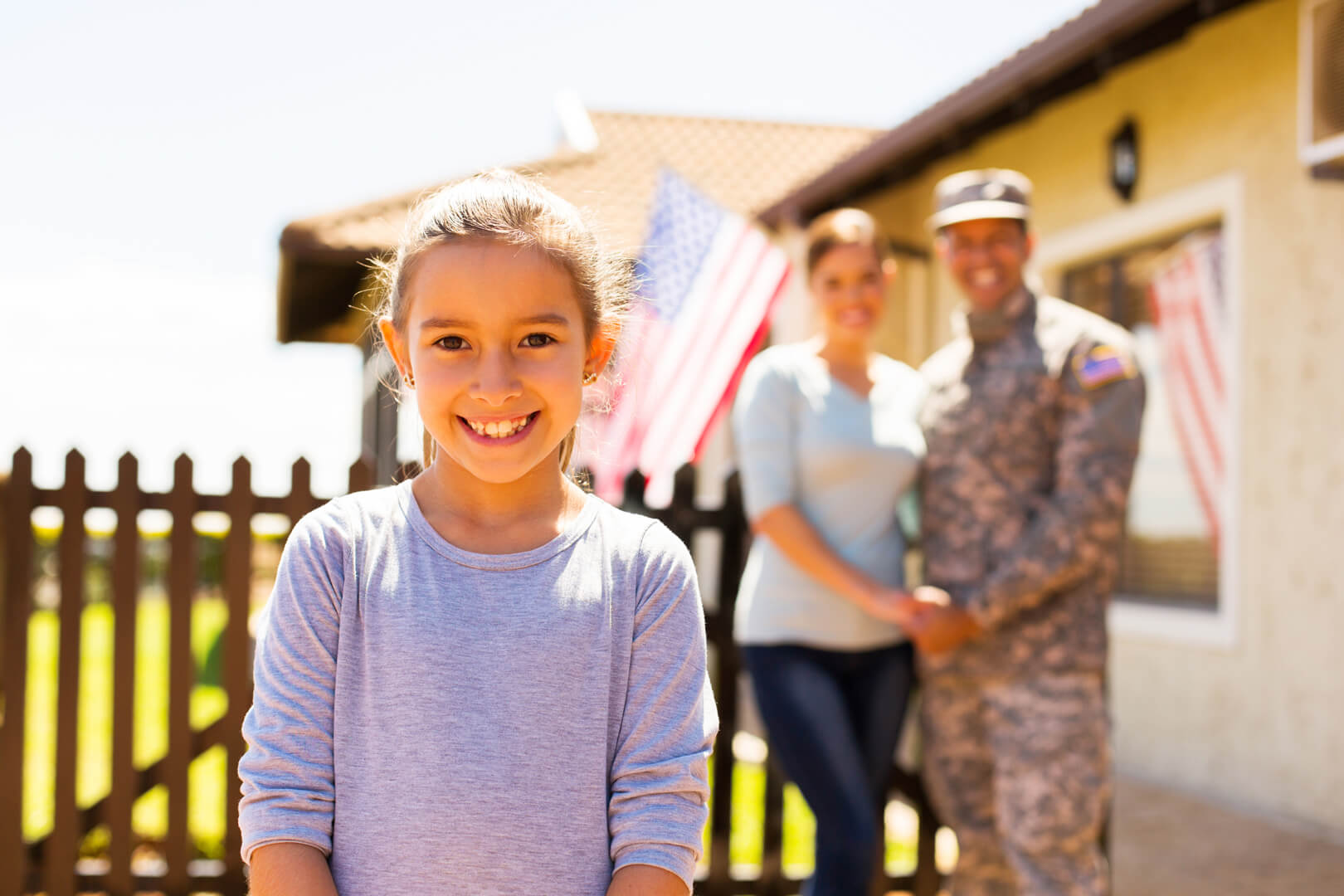 Little girl standing in front of parents